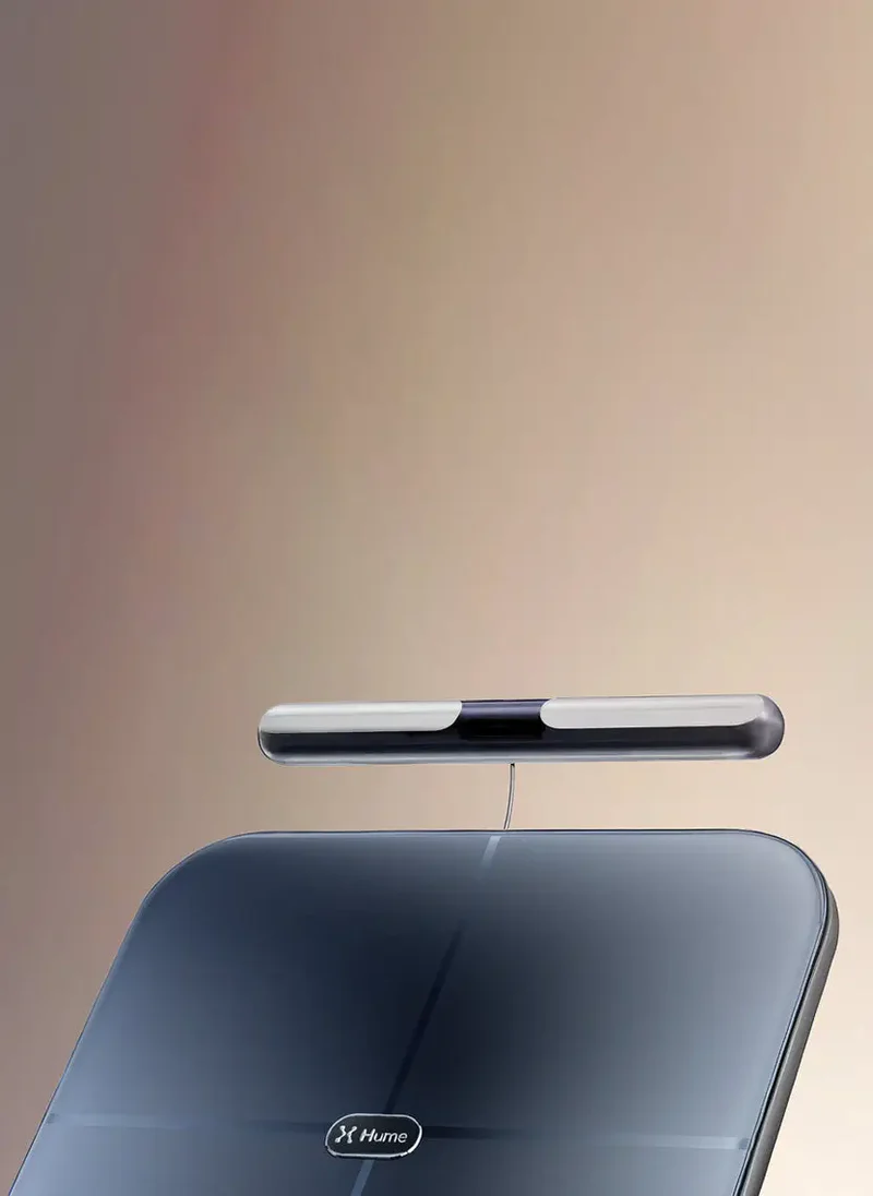 Close-up of Hume Body Pod scale with detachable handlebar sensor, showcasing sleek design for advanced body composition measurement.